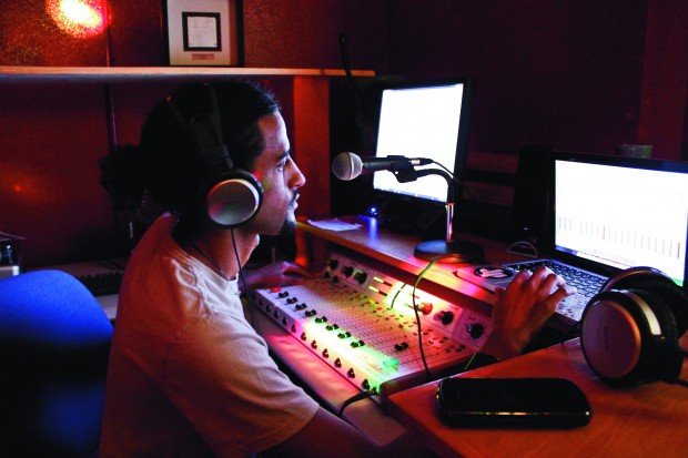 Senior in political science and psychology Khalid Alsomali is a Coog Radio DJ from 11 a.m. to 1 p.m. every Wednesday. Coog Radio is a student run radio station that broadcasts from the second floor of the University Center. | Hendrick Rosemond/The Daily Cougar