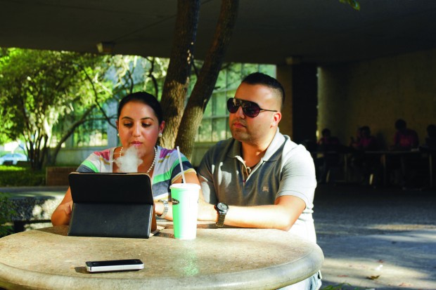 Music performance junior Lucia Aparcio  and industrial construction managment senior Julian Zavala stop to take an e-smoke at the Technology Annex on campus.  |  Samantha Wong/The Daily Cougar