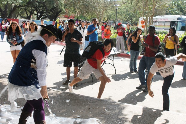 In addition to other activites going on at the fourth annual OctoberFest Kick-off, excited students lined up to “Pie the Pirate.” They found it difficult to land the shaving cream pies on the pirate. | Esteban Portillo/The Daily Cougar