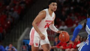 UH guard Quentin Grimes holds the ball at the top of the key as he awaits for the Cougars' offense to develop against Memphis during the 2019-20 regular-season finale. | Mikol Kindle Jr./The Cougar