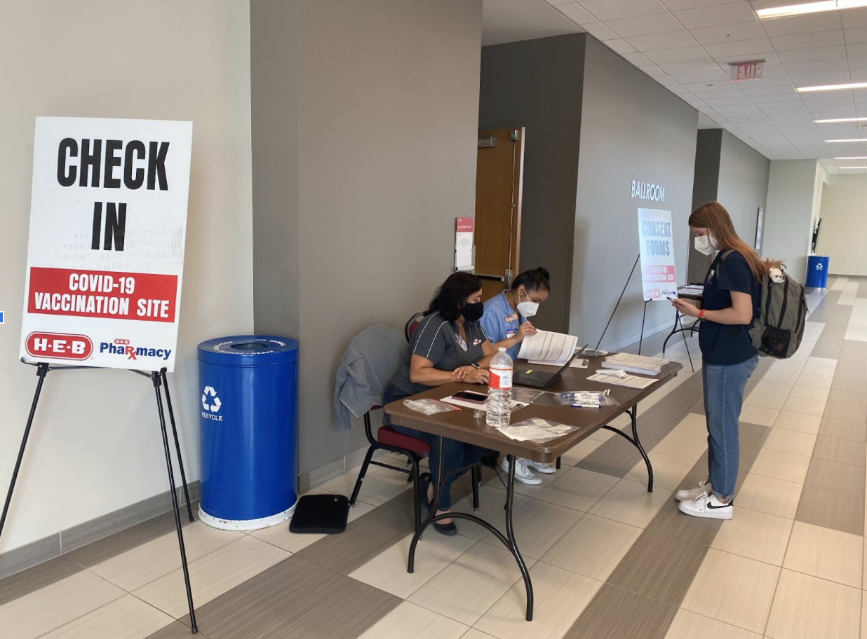 Students check-in at the Student Center South Ballroom to receive their Pfizer or Moderna COVID-19 booster vaccine. | Lisa El-Amin/The Cougar