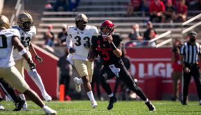 Houston quarterback Clayton Tune scrambles with a flurry of UCF defenders in pursuit as he looks for positive yardage during a regular season game in the 2020 season at TDECU Stadium. | Courtesy of UH athletics