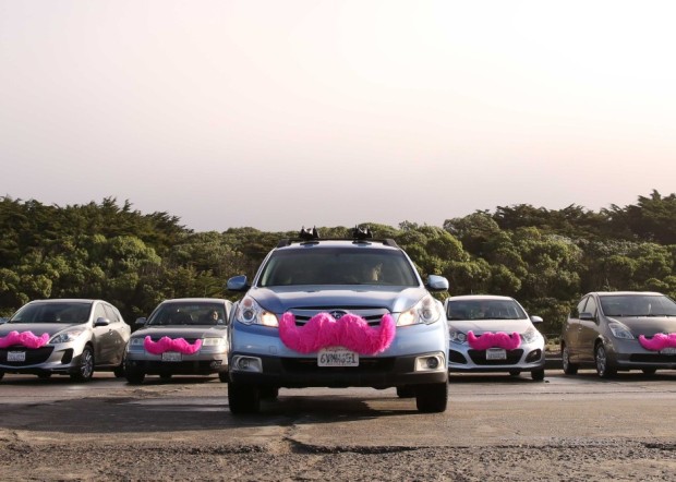 Lyft drivers are distinguished by a pink, fuzzy mustache placed on the front of their vehicle.