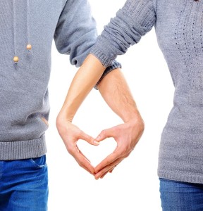 Valentine Couple in love showing Heart with their fingers. Love