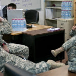 First Lt. Janill Castillo, a native of Bronx, N.Y., discusses training events with her soldiers at the EOD detachment on Camp Bondsteel Feb 25. The team's mission is to help train multinational EOD teams and, if the need called for it, responding to ordnance uncovered from the Kosovo War.