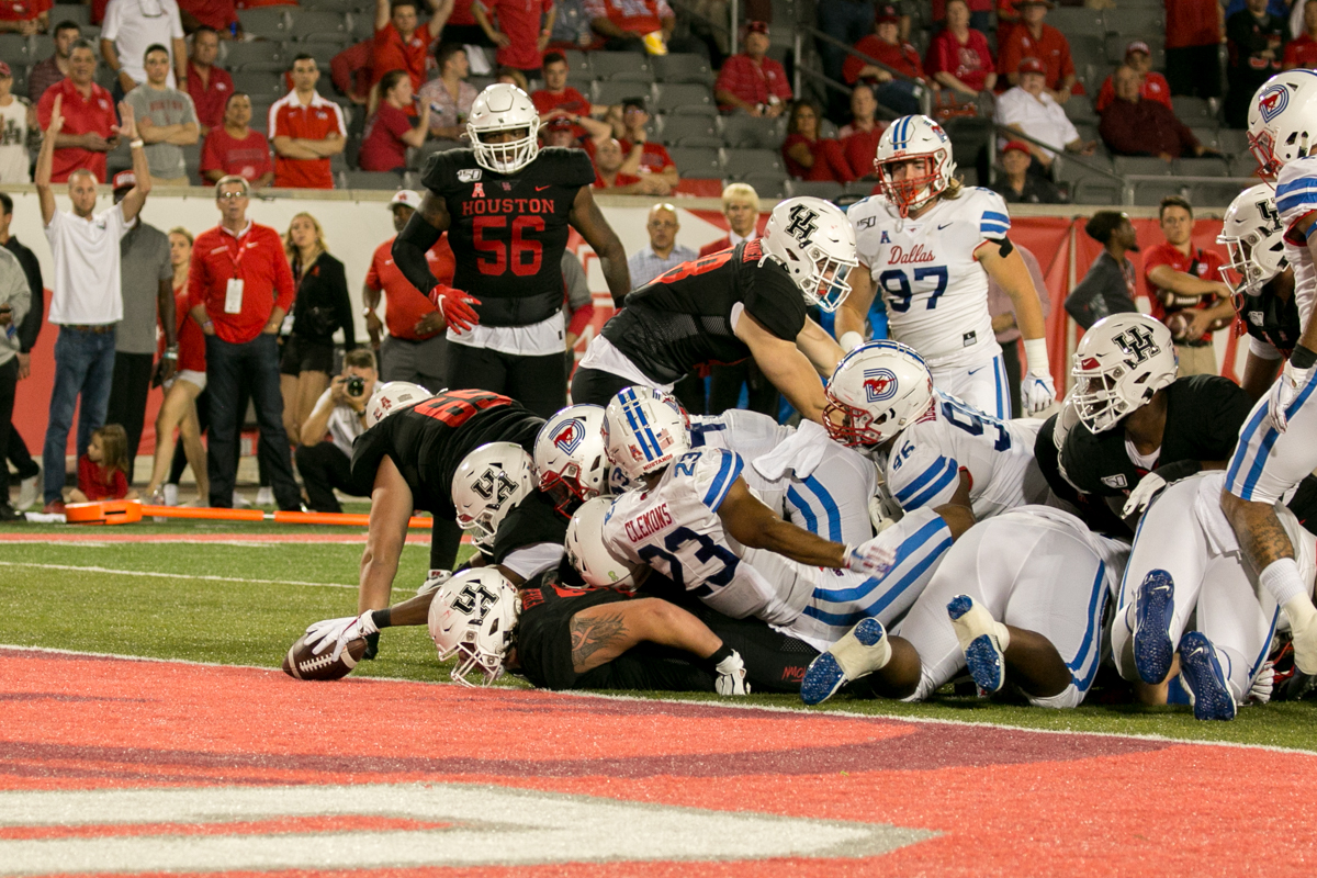 Houston and SMU players converge at the goal line as the Mustangs try to keep the Cougars out of the end zone in a regular season game during the 2019 season at TDECU Stadium. | Katrina Martinez/The Cougar