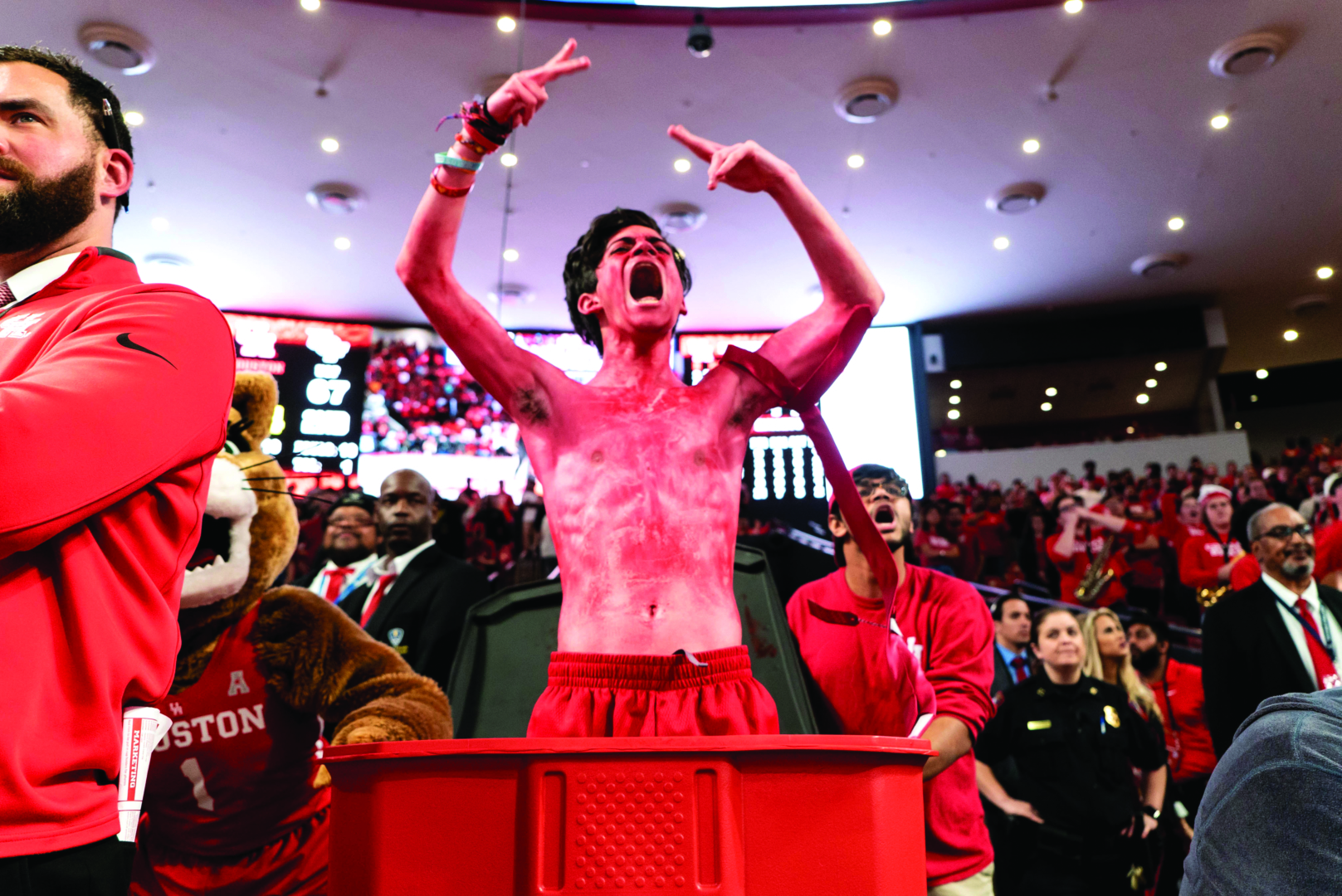 Luis Lemus stands courtside during a basketball game in the red trash can that completes his game-day persona. Lemus portrayed Trash Can Man during several of the men's basketball conference games last season and hopes to continue doing so for the up coming season. | File photo