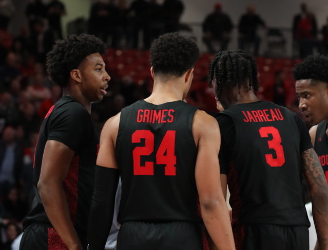 Nate Hinton, left, Quentin Grimes, center, and Dejon Jarreau, right, huddling up during a game. All three guards have at least one game with nine rebounds in the 2019-20 season. | Mikol Kindle Jr./The Cougar
