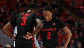 UH guards DeJon Jarreau (3) and Caleb Mills (2) huddle together around head coach Kelvin Sampson as he gives instruction in a regular season game during the 2019-20 season at Fertitta Center. | Mikol Kindle Jr./The Cougar