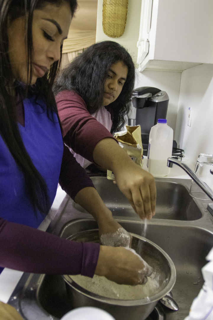 Magdalena Pineda (left) and her daughter, Celine Pineda make traditional Navajo fry bread. Although they weren't raised in the Navajo Nation, Magdalena Pineda passed her indigenous heritage to her two kids by showing them traditional foods. | Katrina Martinez/The Cougar