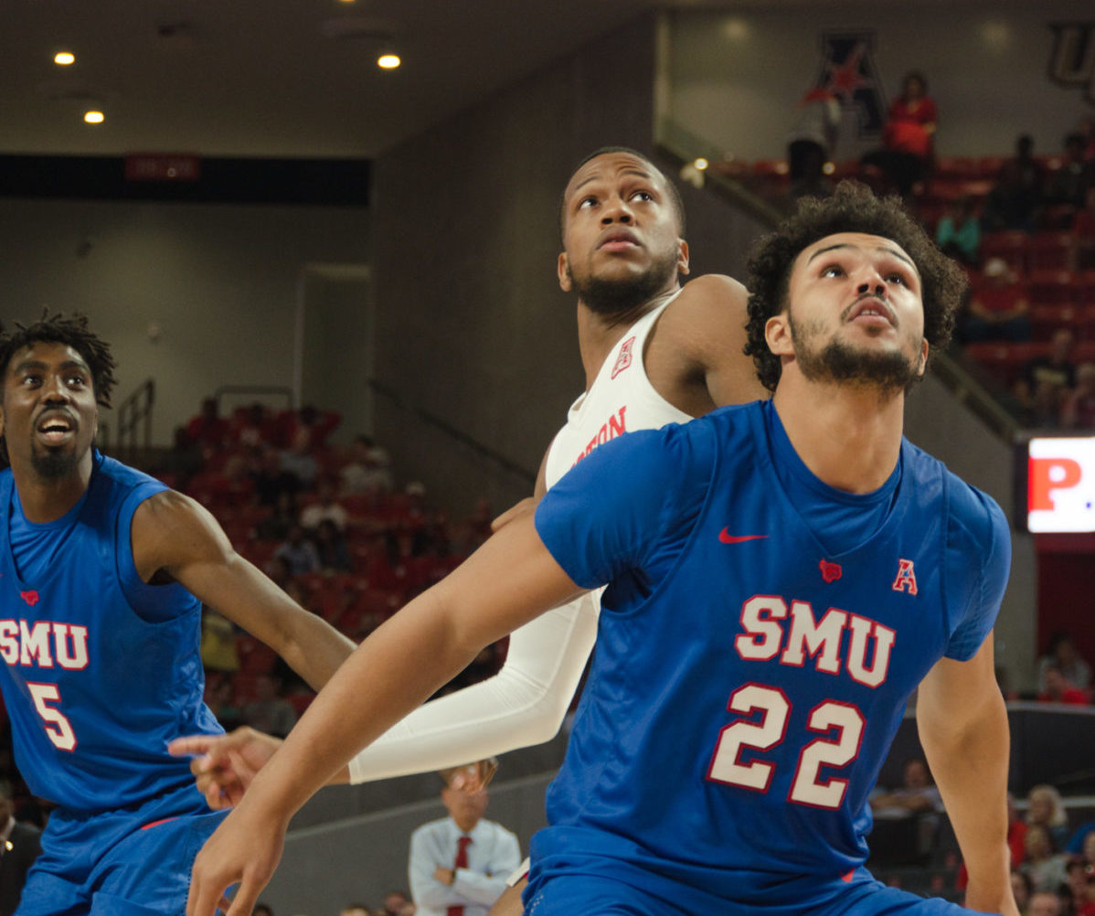 UH forward Justin Gorham fights off an SMU player as both look up at the basket for a potential rebound during the 2019-20 season. In Sunday's game between UH and SMU, Gorham had a career-high 19 rebounds in the Cougars' win. | Lino Sandil/The Cougar