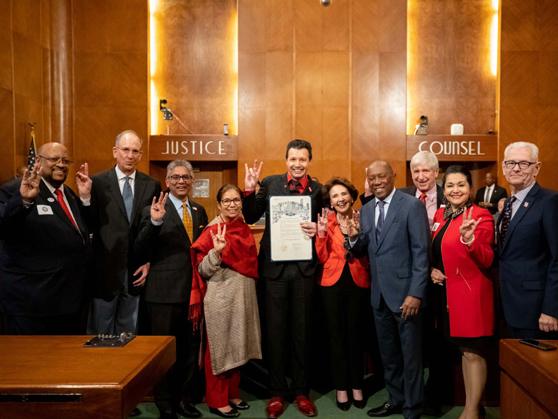 Dean Paul A. Pavlou holding the proclamation Mayor Turner signed on March 3, 2020.