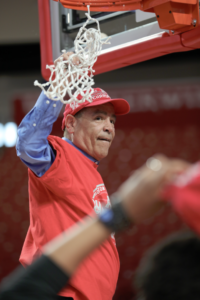 Kelvin Sampson cutting down the nets on March 8 after Houston clinched a share of the AAC regular season championship. | Mikol Kindle Jr./The Cougar