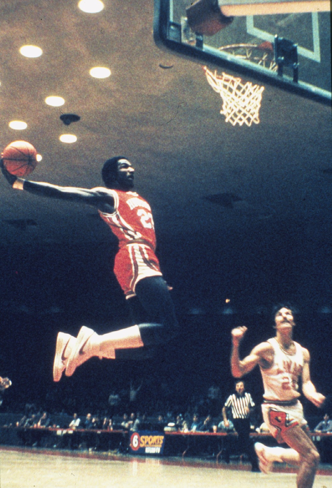 Guard Clyde "The Glide" Drexler soaring through the air for a dunk. He was an instrumental piece for the "Phi Slama Jama" team.