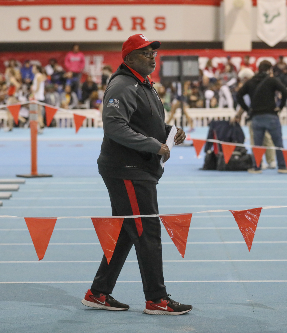 Head track and field coach Leroy Burrell watching his team compete at a meet | Courtesy of UH Athletics