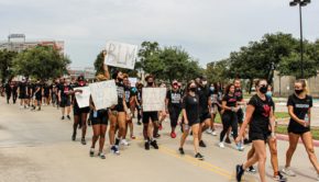 Demonstrators on Saturday brought various signs for the march. Some had the letters "BLM," which stand for Black Lives Matter, and others included the phrase, "how many more?" Which regarding the shooting of African Americans at the hands of police officers. | Donna Keeya/The Cougar