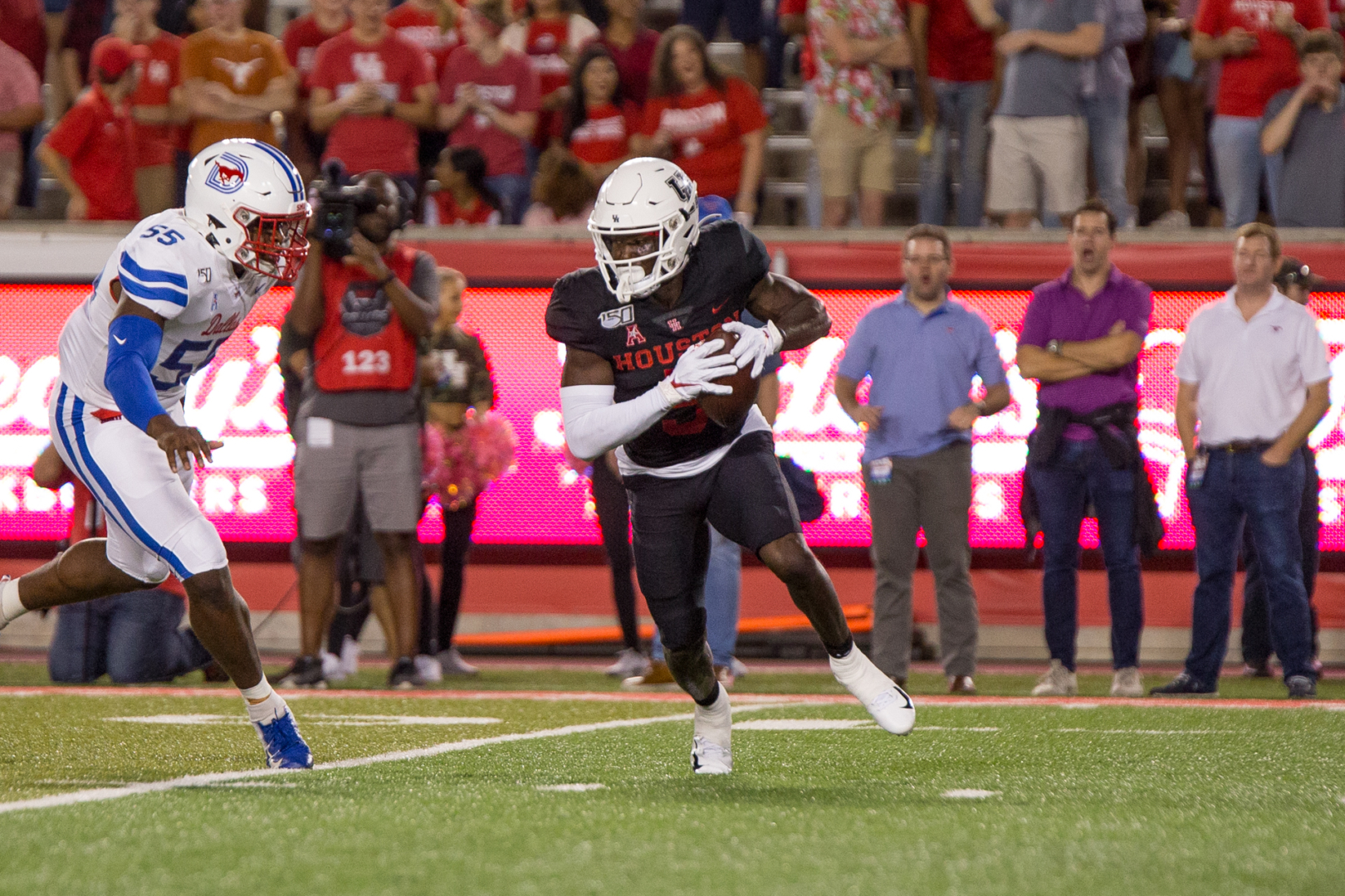 UH football receiver Marquez Stevenson tries to speed past an SMU defender during the 2019 season. | Trevor Nolley/The Cougar