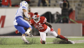 UH junior free safety Gervarrius Owens slides on one knee trying to wrap up BYU junior running back Lopini Katoa. | Courtesy of UH athletics