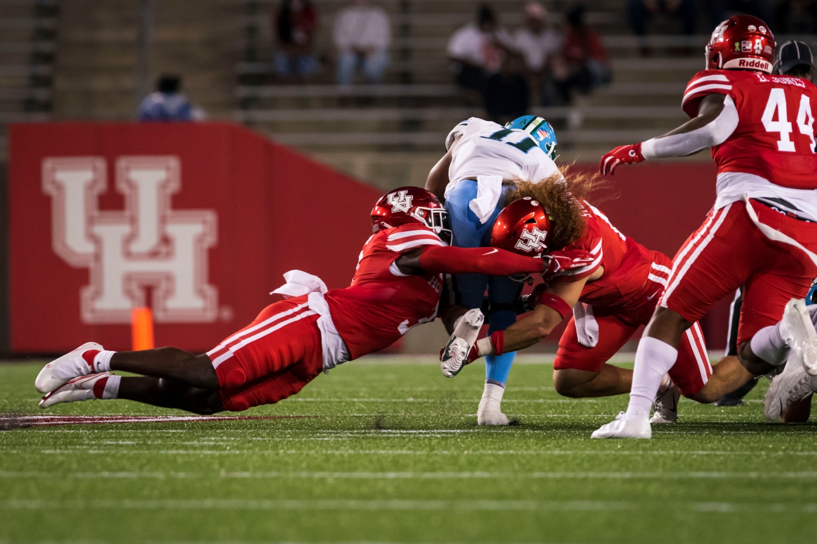 Senior linebacker Grant Stuard joins a teammate in bringing down a Tulane player during the 2020 opener at TDECU Stadium | Courtesy of UH athletics