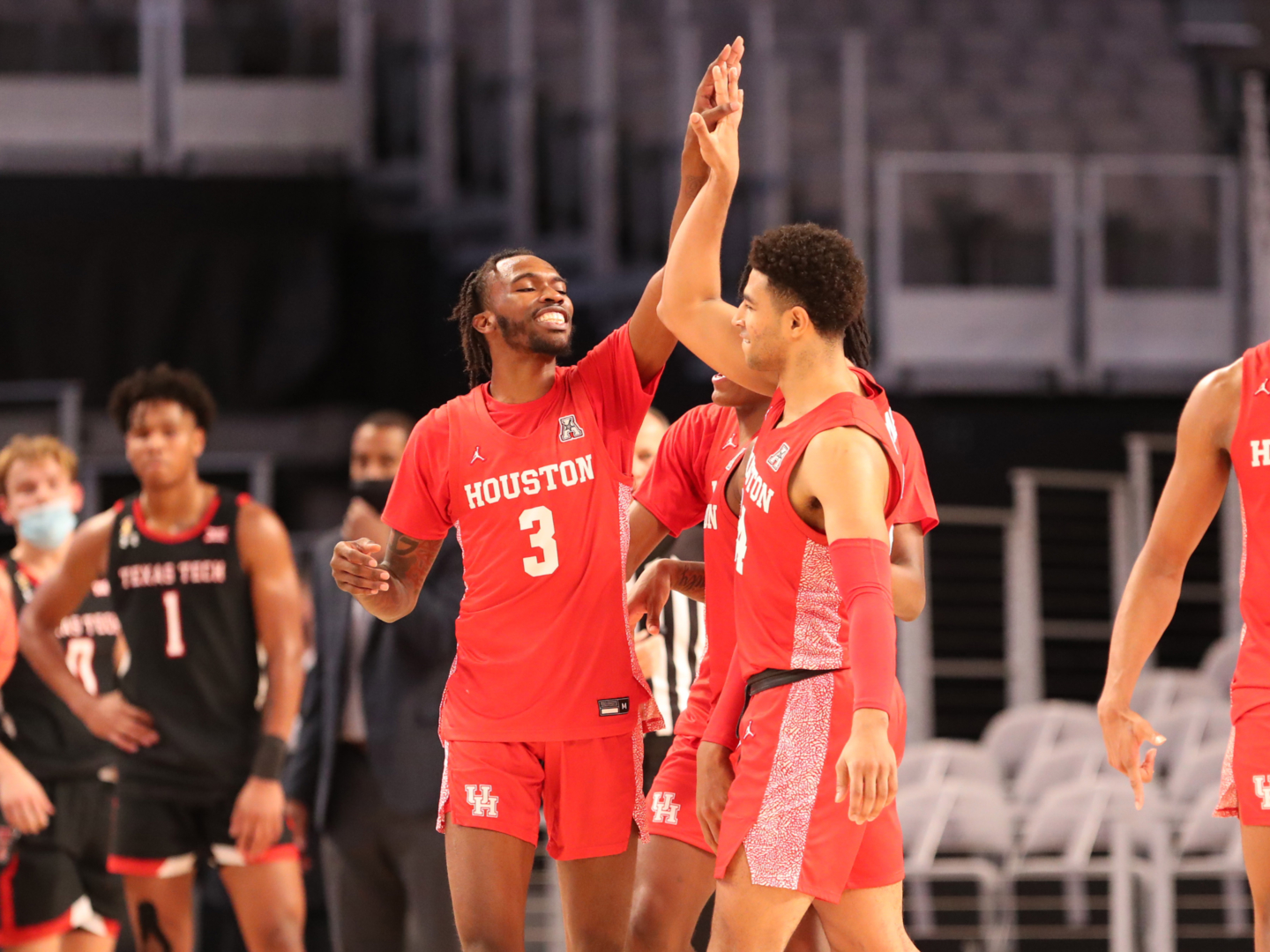 UH guards DeJon Jarreau (3) and Quentin Grimes celebrate with a high five during a break in its game against No. 14 Texas Tech at Dickies Arena in Fort Worth. | Courtesy of UH athletics