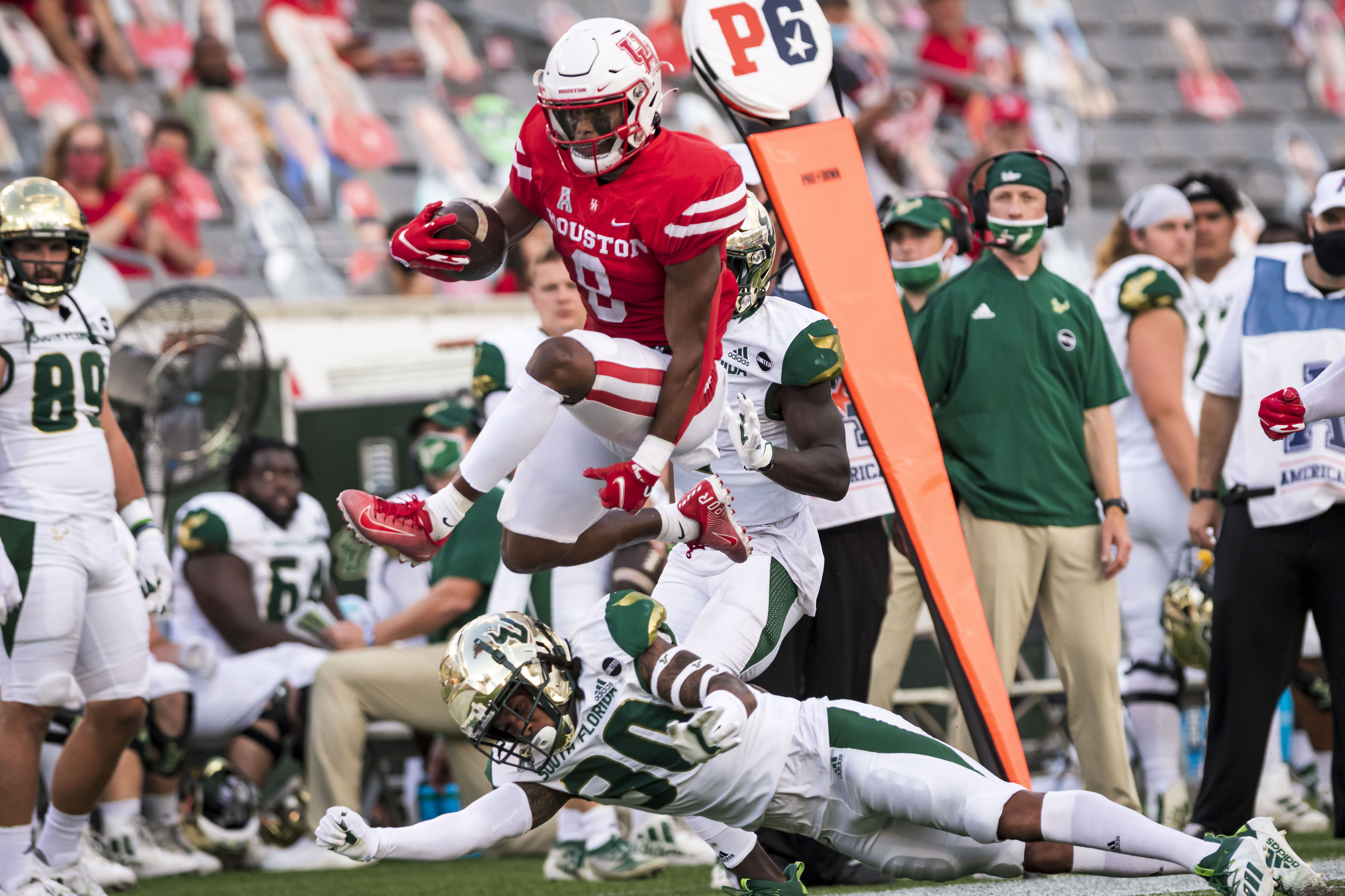 UH football cornerback Marcus Jones hurdles over a USF defender in the Cougars’ 56-21 victory earlier in the season. Head coach Dana Holgorsen has praised Jones throughout the season, calling him the best punt returner in the country. | Courtesy of UH athletics