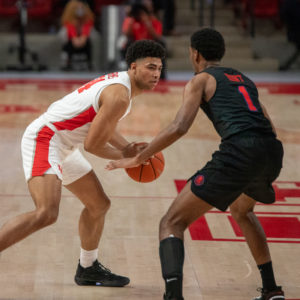 UH guard Quentin Grimes holds the ball with an SMU defender in front of him during a game in the 2020-21 season at Fertitta Center. The UH men's basketball team was announced as a two-seed in the NCAA's in-season bracket show on Saturday. | Andy Yanez/The Cougar