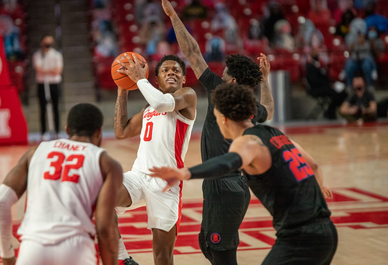 Sophomore guard Marcus Sasser (0) rises up for a contested shot against SMU in a regular season game on Jan. 31 at Fertitta Center. UH climbed in the AP Poll after another perfect week. | Andy Yanez/The Cougar