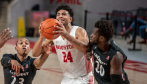 Houston men's basketball guard Quentin Grimes (24) drives through Cincinnati defenders for a layup on Sunday at Fertitta Center. The UH men's basketball team will host Western Kentucky on Thursday. | Andy Yanez/The Cougar