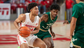 UH men's basketball guard Quentin Grimes (24) drives past USF senior guard Justin Brown during Sunday's game at Fertitta Center. | Andy Yanez/The Cougar