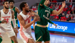 UH forward Justin Gorham (4) fights off USF's David Collins for a rebound on Sunday afternoon at Fertitta Center. | Andy Yanez/The Cougar