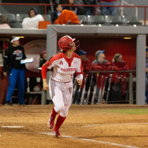Houston catcher Kati Ray Brown watches a ball as it heads over the fence. The UH softball team opened its 2021 season on Friday against Lamar. | Deaunte Johnson/The Cougar