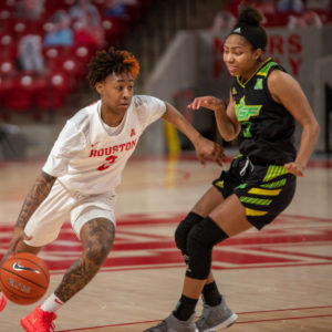UH women's basketball guard Miya Crump (2) drives past a USF defender on Feb. 27 inside of Fertitta Center. Crump tied an AAC-record with six steals on Tuesday during the UH women's basketball team's game against ECU. | Andy Yanez/The Cougar
