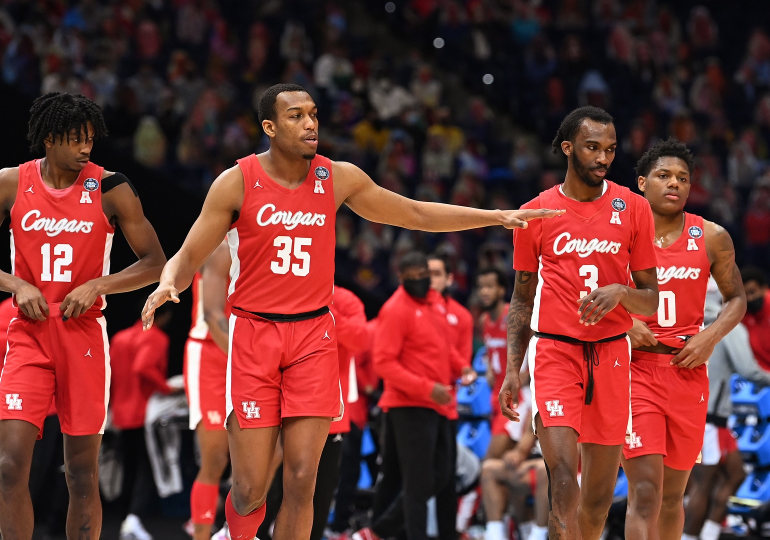 Tramon Mark (12), Reggie Chaney (32), DeJon Jarreau (3) and Marcus Sasser (0) of the UH Cougars walk across the court during the first half of their game against the Baylor Bears in the Final Four semifinal game of the 2021 NCAA Men's Basketball Tournament at Lucas Oil Stadium on April 3 in Indianapolis. | Photo by Brett Wilhelm/NCAA Photos via Getty Images