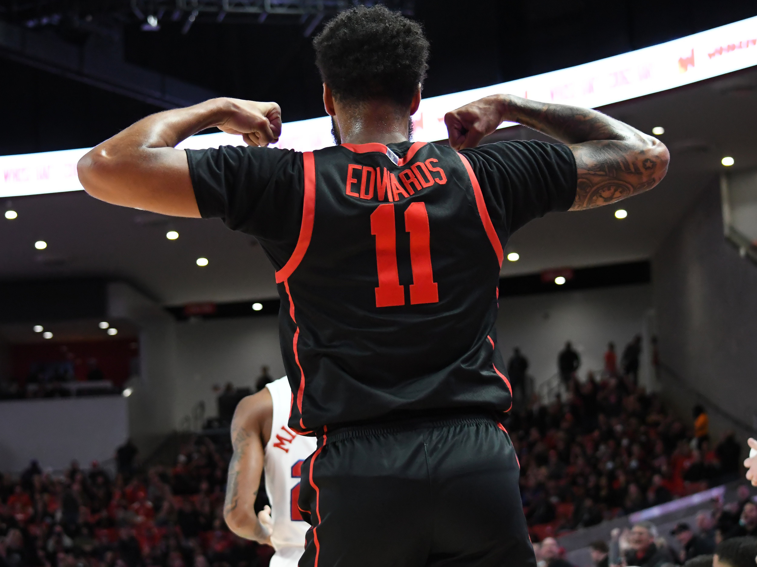 UH guard Kyler Edwards flexes after converting a layup through contact in the first half of the Cougars' victory over SMU on Sunday afternoon at Fertitta Center. | Steven Paultanis/The Cougar
