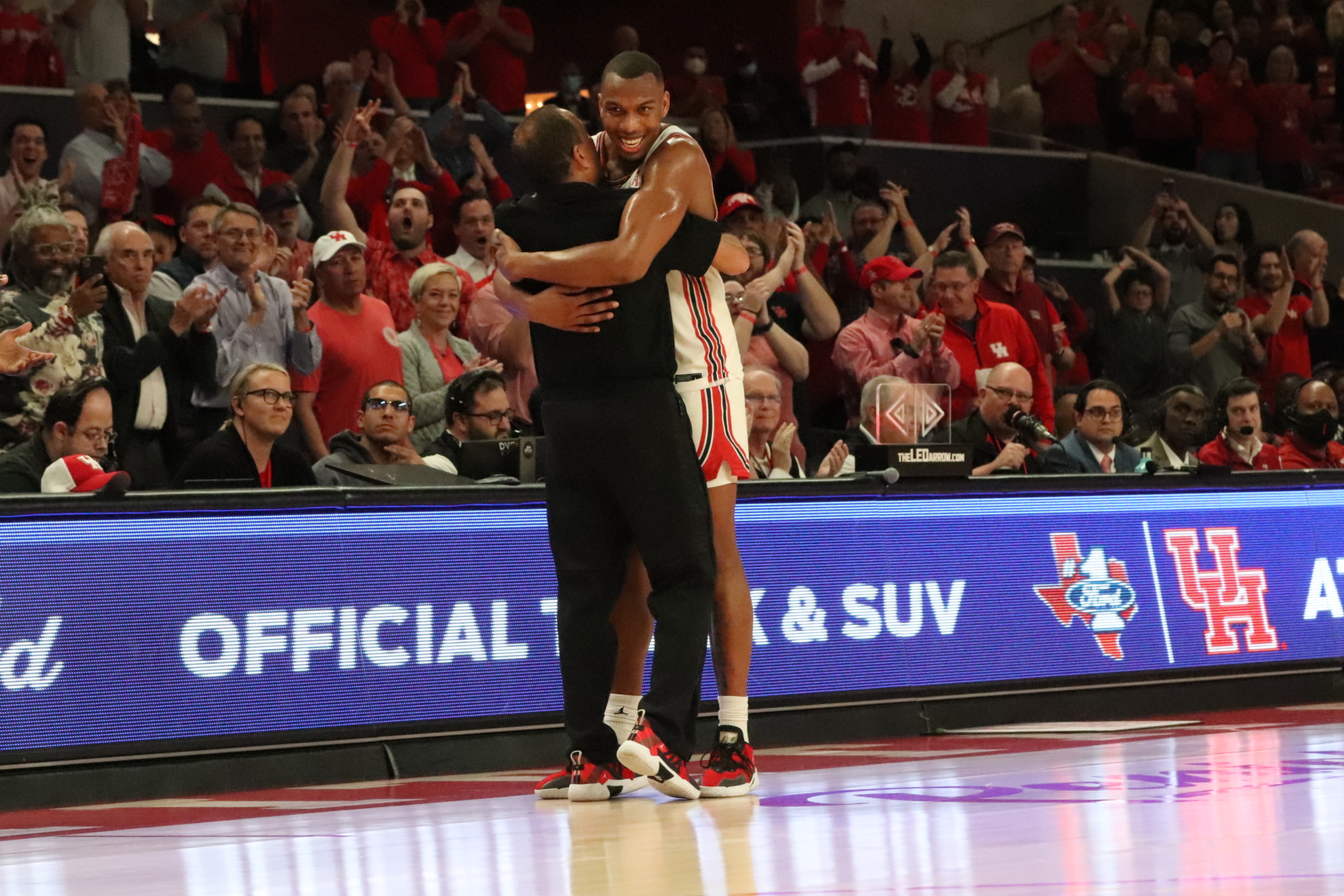 Kelvin Sampson embraces Fabian White Jr. as the all-time winningest player in UH basketball program history walked off the Fertitta Center court for the last time of his career. | Armando Yanez/The Cougar