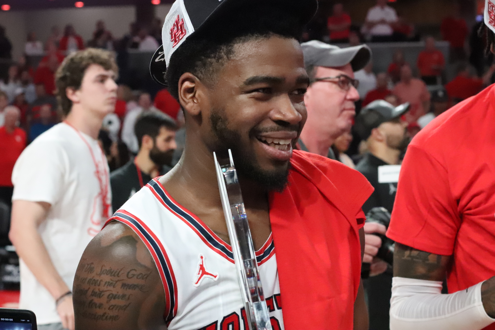 Jamal Shead holds the AAC regular season trophy after UH basketball's win over Temple on Thursday night at Fertitta Center. | Armando Yanez/The Cougar