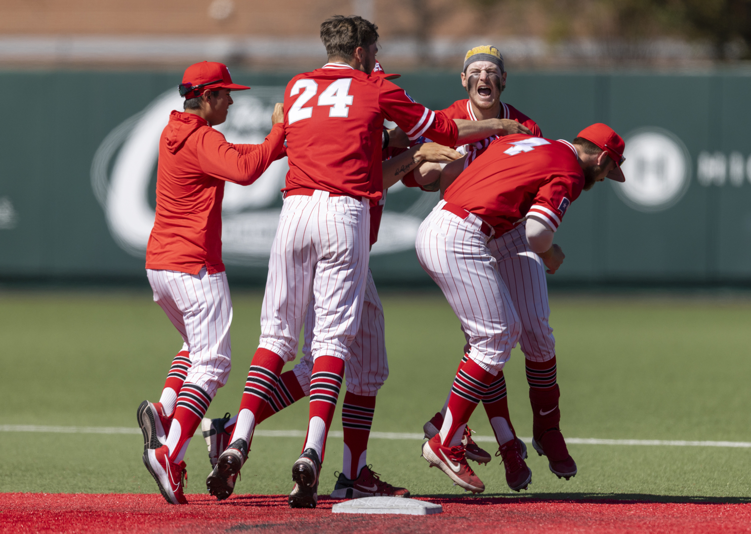 Ian McMillan is mobbed by his teammates after his walk-off double on Sunday afternoon to give UH baseball a series victory over Wichita State. | Courtesy of Tom Shea/UH athletics