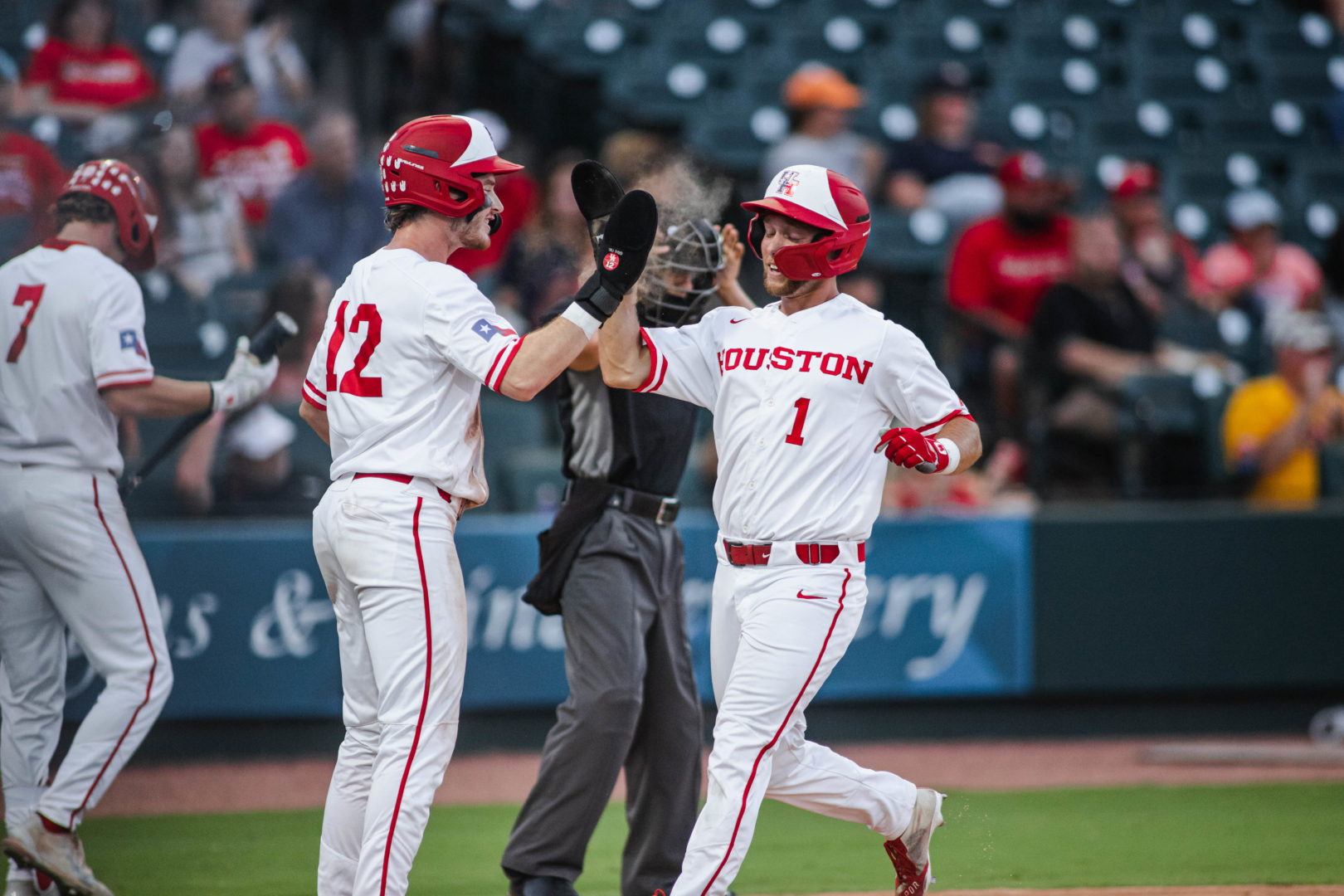 Ian McMillian greets Brandon Burckel after the pair scored off Brandon Uhse's RBI single in the bottom of the fourth during UH baseball's win over Sam Houston on Tuesday night. | James Schillinger/The Cougar
