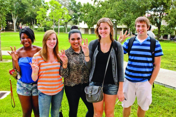 Freshmen pose with their newly-learned Cougar paws near Cougar Village. From left to right: Whitney Walters, Morgan McBurnett, Gabriela Blanco, Lauren Poland and Beau Enochs.  |  Hendrick Rosemond/The Daily Cougar