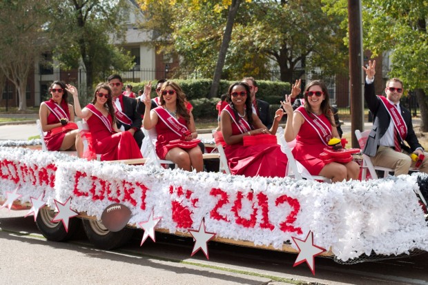 The 2012 Homecoming Court rode in the annual fall parade Saturday before the UH vs. Tulsa game. The event invited alumni and studentsout to wear red and celebrate their University along Cullen Boulevard. | Hannah Laamoumi/The Daily Cougar