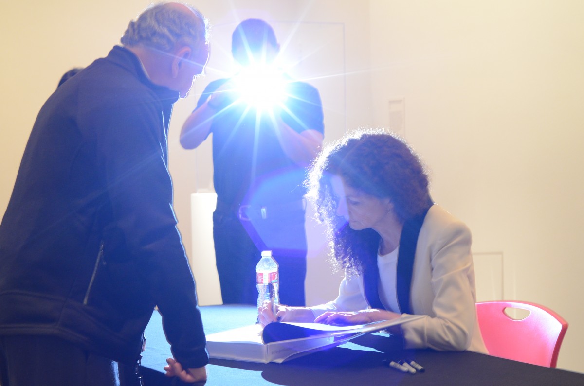 New York Times Magazine’s photography director Kathy Ryan signs copies of her book, “New York Times Magazine Photographs.”. | Emily Chambers /The Daily Cougar