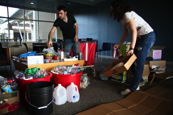 Students use recyclables to create art that will be submitted to the Art of Recycling contest, part of RecyleMania. Cougar Village Service Committee member Blythe Nguyen said the event was about raising awareness for recycling. | Chris Luong/The Daily Cougar