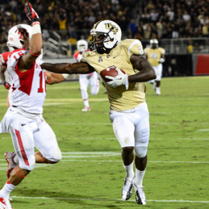 UCF junior running back Storm Johnson kept UH defenders at an arm’s length away for most of the evening, rushing for 127 yards. | Samantha Henry/Central Florida Future