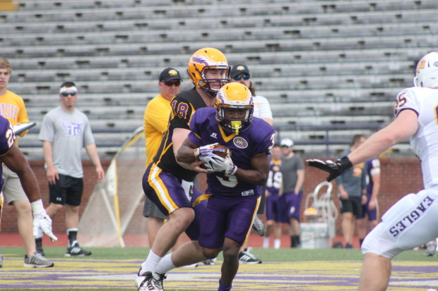 Tech junior quarterback hands the ball off to senior running back Ladarius Vanlier during the team's Purple vs. Gold spring scrimmage in April.