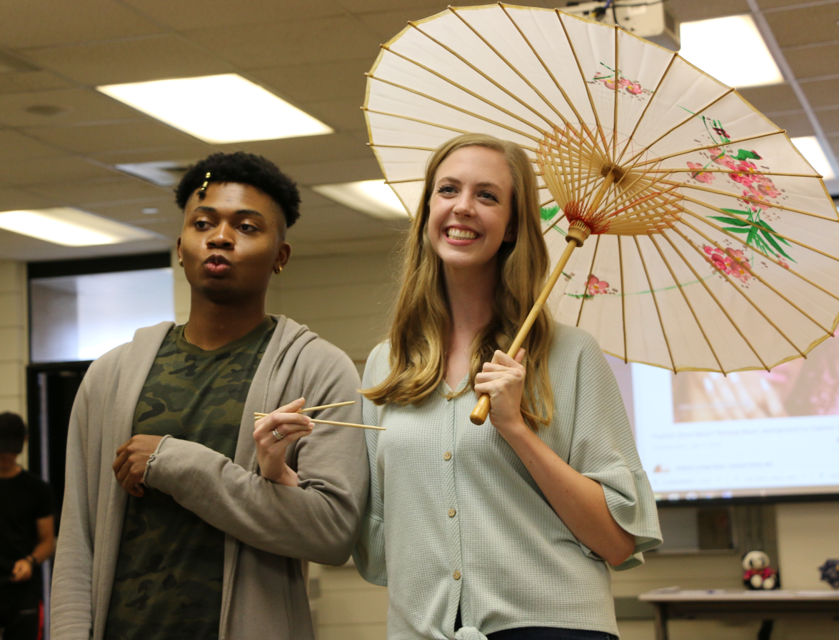 Marcus Jones (left) showing off traditional Chinese fashion at the Mid-Autumn Festival's fashion show.  | Sydney Rose/The Cougar
