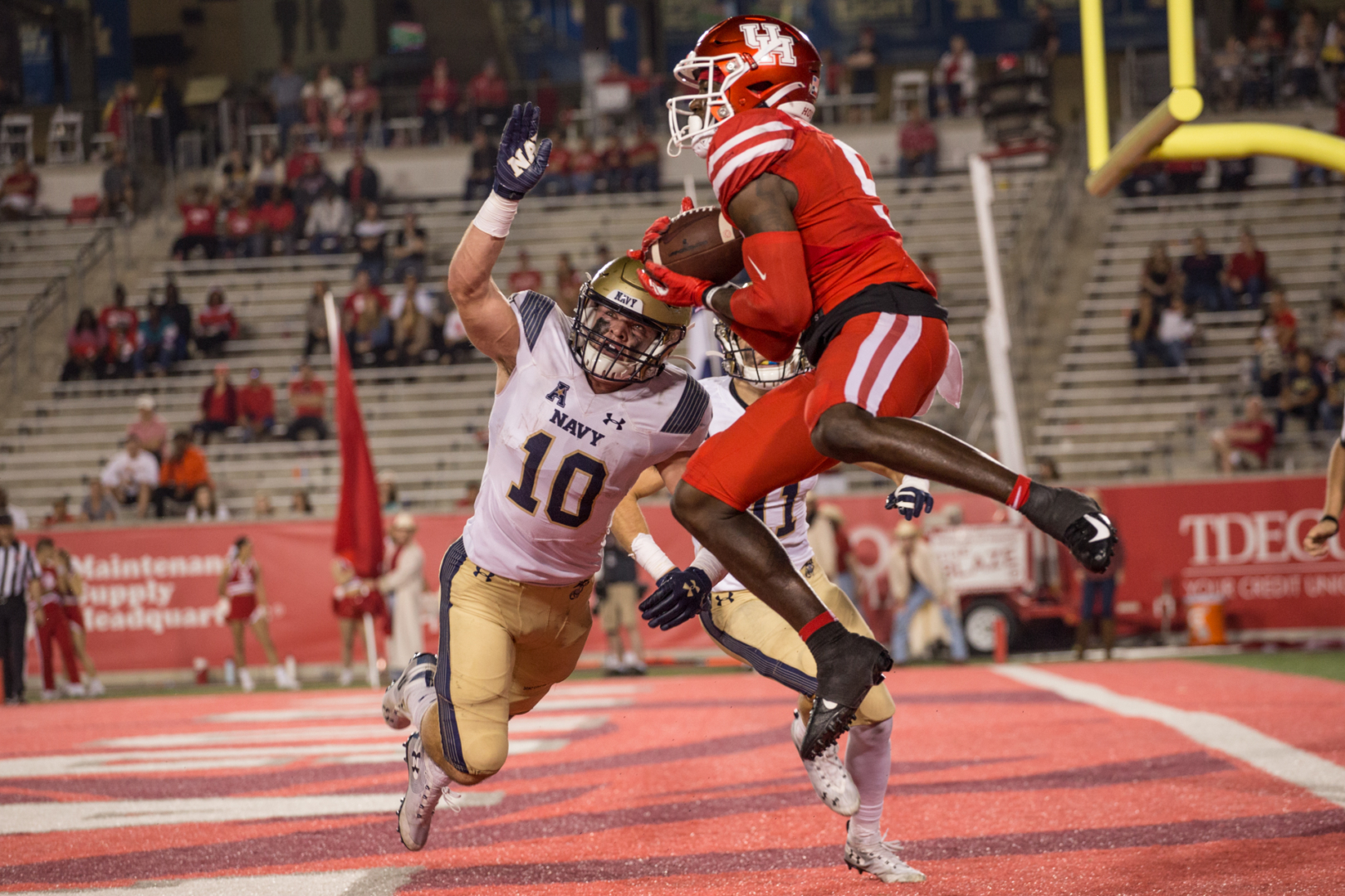 UH receiver Marquez Stevenson skies over Navy safety Kevin Brennan in the end zone during an AAC battle in the 2019 season at TDECU Stadium. | Trevor Nolley/The Cougar
