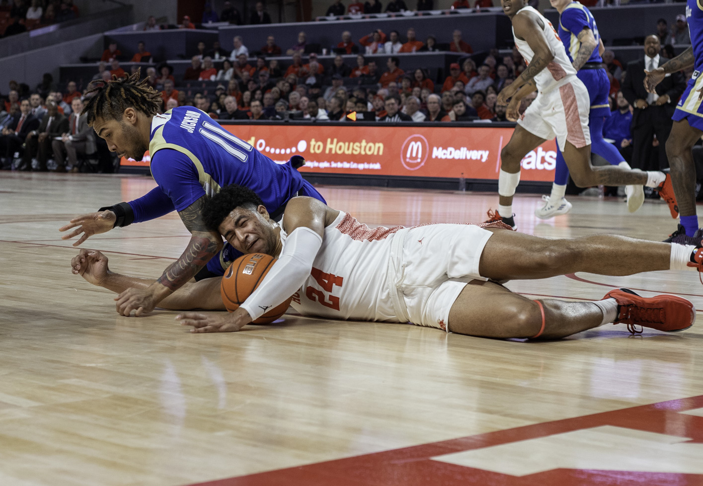 Houston guard Quentin Grimes dives on the floor and secures a loose ball in a game at Fertitta Center during the 2019-20 season. | File Photo