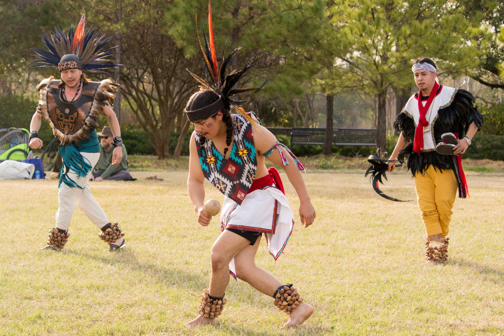 Jesus Navarro (left), Mauricio Turrubiartes III (center) and Uriel Garcia-Vega (right) of the Houston Aztec Dance group partake in a traditional dance ceremony to honor the last Mexica-Aztec tlatoani-leader, Cuauhtémoc. The group meets weekly to learn the Aztec traditions and ceremonies as a way to reconnect with their indigenous heritage. | Katrina Martinez/The Cougar