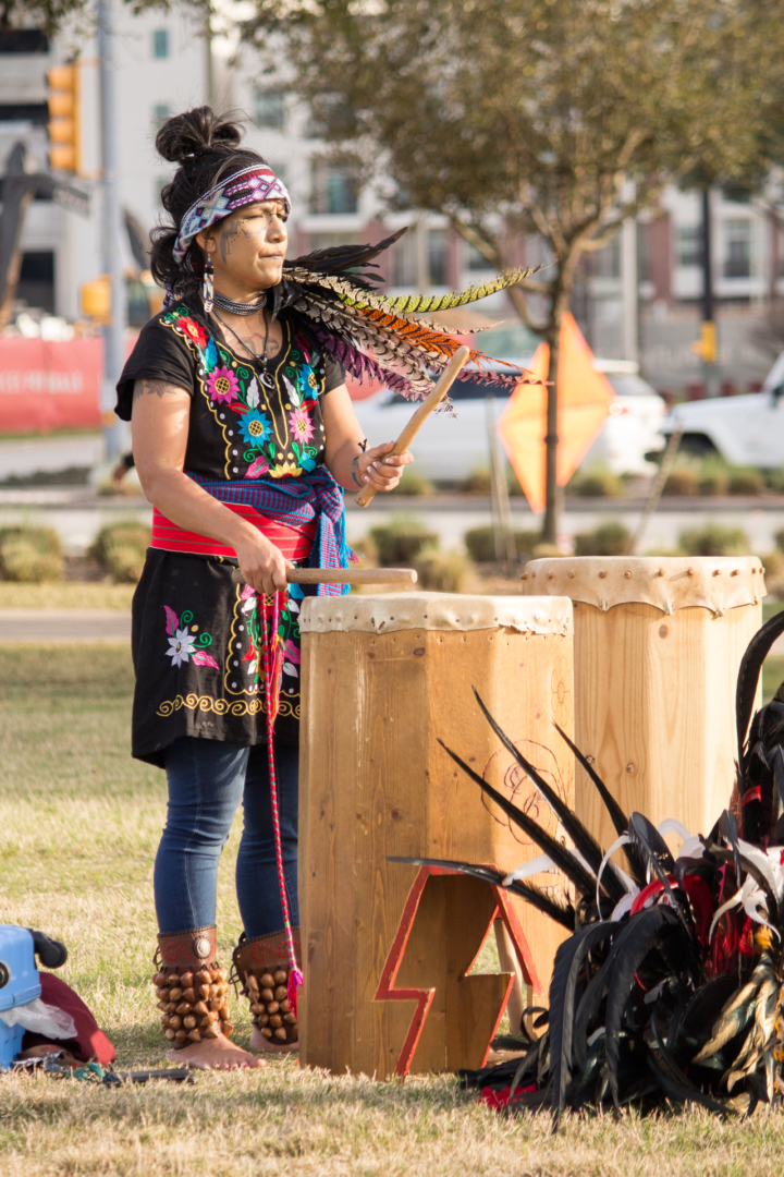 Abuela M'api leads the Houston Aztec Dance group in their traditional dance by playing the drums. As a way to spread her culture she teaches free Aztec dance classes at Moody Park. | Katrina Martinez/The Cougar