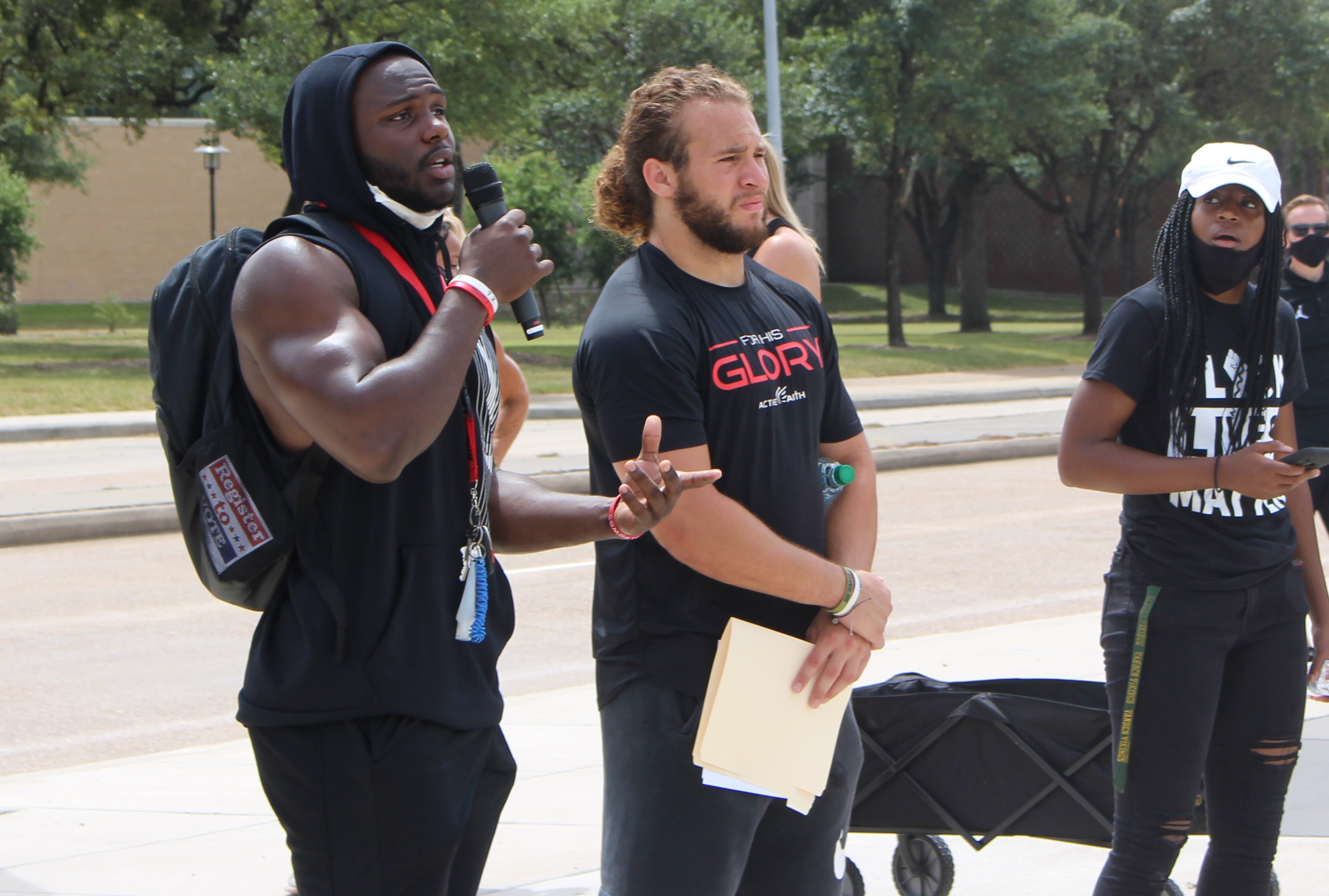 Senior linebacker Grant Stuard (middle) on why he has used his voice to advocate for equality: "I saw my team fighting against each other. So I took it upon myself to educate myself about everybody’s opinion, everybody’s beliefs and to understand that unity is the only way we can move forward." | Donna Keeya/The Cougar
